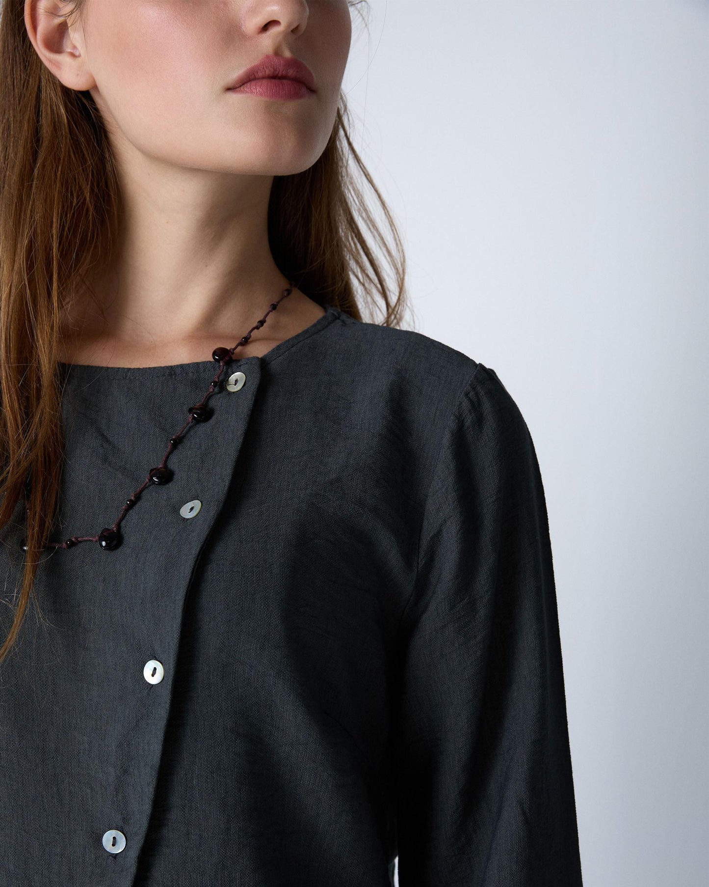Blusa cinzenta com botões assimétricos